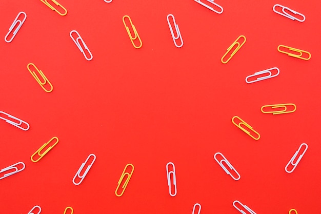 Paper clips on red background