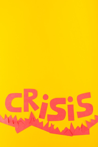 Free photo paper crisis lettering on yellow background