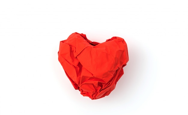 Paper crumpled heart on white background .