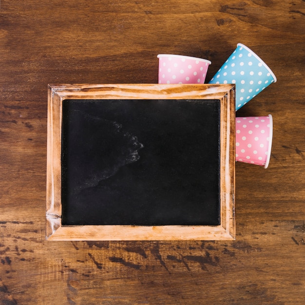 Paper cups under blackboard