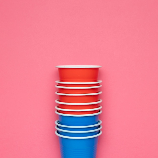 Paper cups on pink background