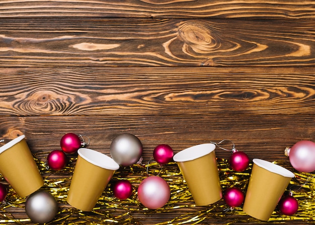 Free photo paper cups with baubles on table