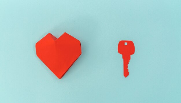 Paper cut of Key for heart as a symbol of love .