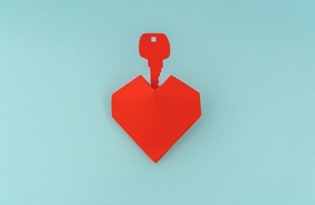 Paper cut of Key for heart as a symbol of love .