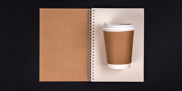 Paper disposable cup and notepad made from recycled materials top view