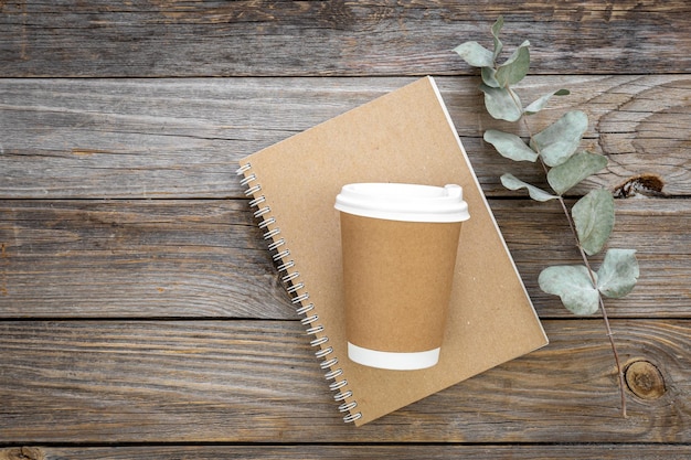 Paper disposable cup and notepad made from recycled paper cups top view