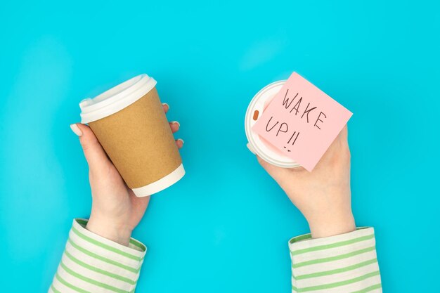 Paper disposable cups and paper reminder with text wake up
