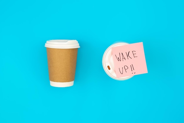 Free photo paper disposable cups and paper reminder with text wake up