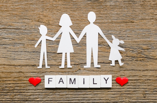 Paper family composition on wooden background