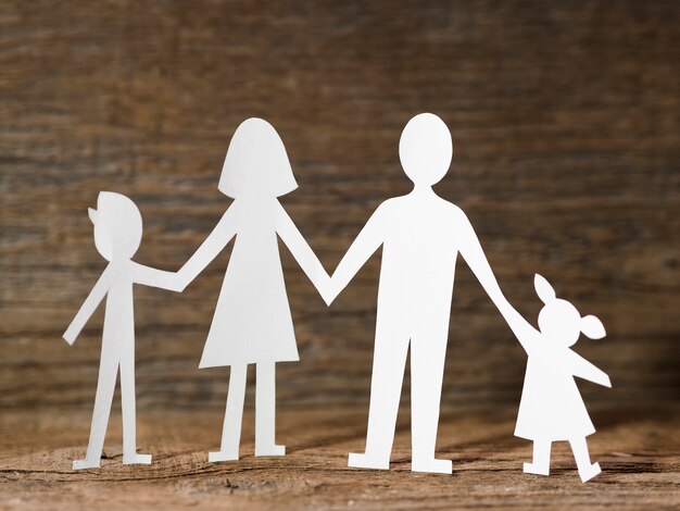 Paper family on wooden background