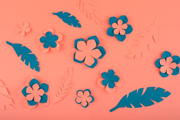 paper flowers and leaves on coral background