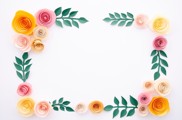 Paper flowers and leaves on white background