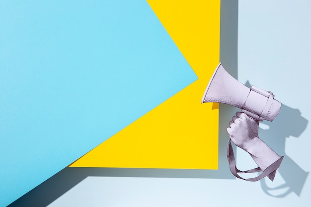 Free photo paper hand holding megaphone