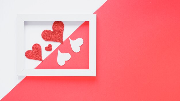 Paper hearts between photo frame