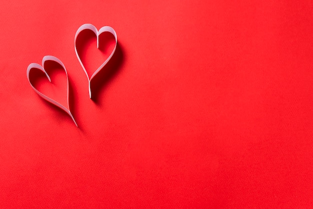 Paper hearts on red background