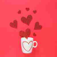 Free photo paper hearts scattered from cup