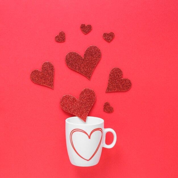 Paper hearts scattered from cup