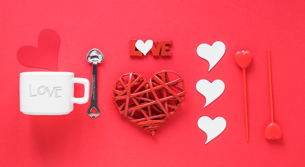 Free photo paper hearts with cup on table