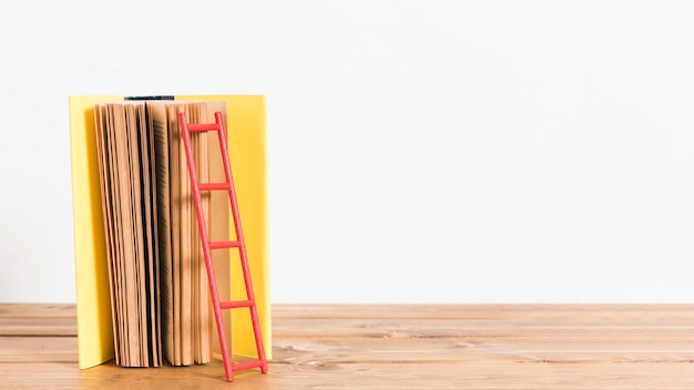 Paper ladder on old yellow book 