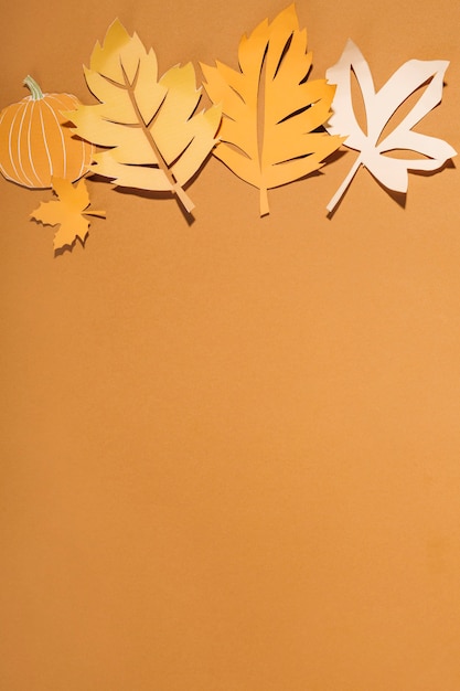 Paper leaflets with pumpkin on table