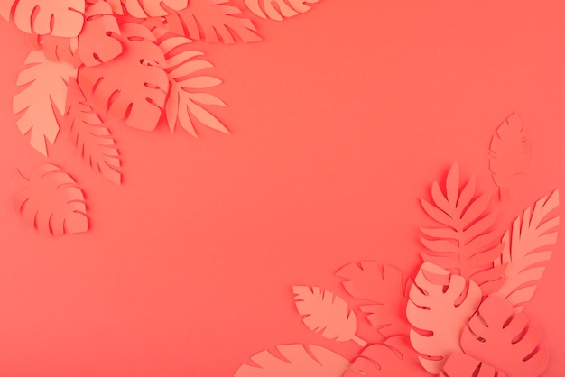 Paper leaves on coral background