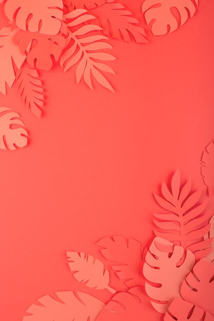 Paper leaves on coral background