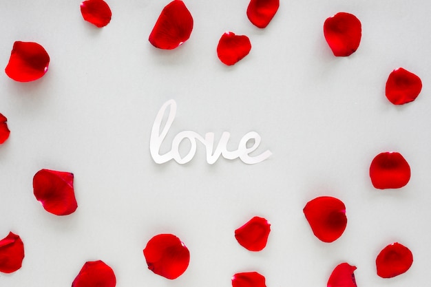 Paper Love inscription with rose petals on table