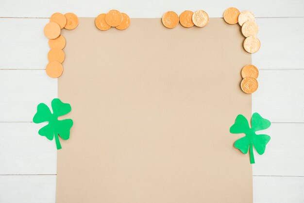 Paper near coins and decorative clovers