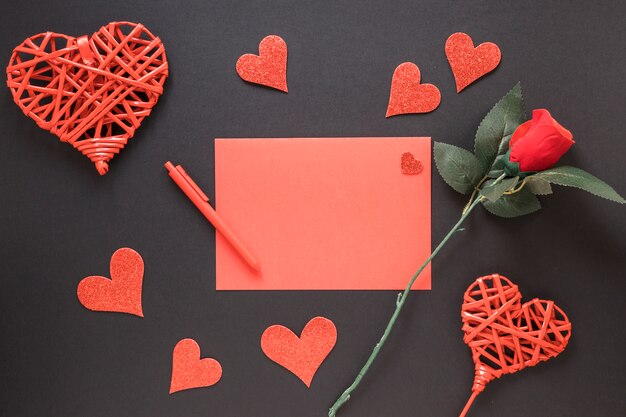 Paper near pen, ornament hearts and flower 