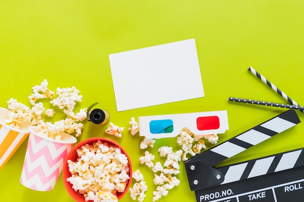 Free photo paper near popcorn, clapboard and 3d glasses