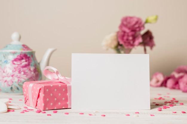 Free photo paper near present box and teapot