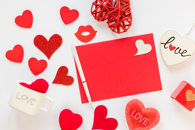 Paper and pen with hearts for valentines