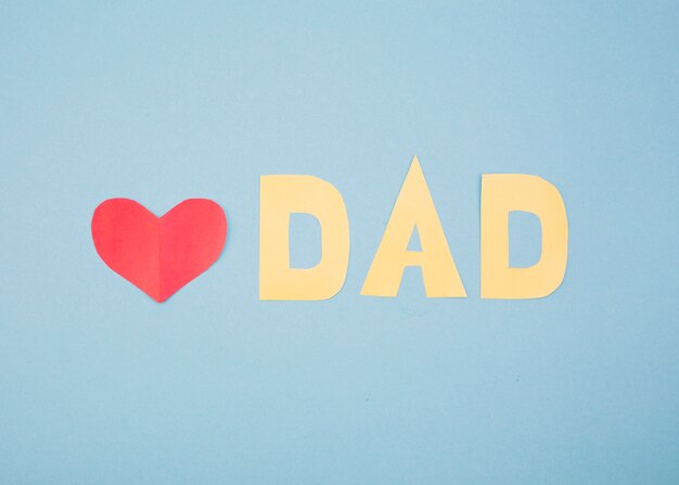 Paper red heart and dad title
