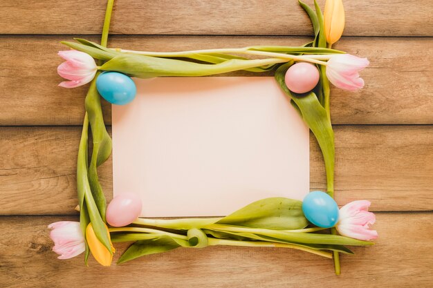 Paper sheet in tulips and eggs frame