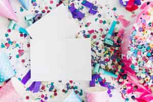 Free photo paper sheets on confetti near party stuff