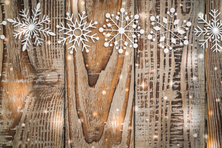 Free Photo paper snowflakes on wooden background