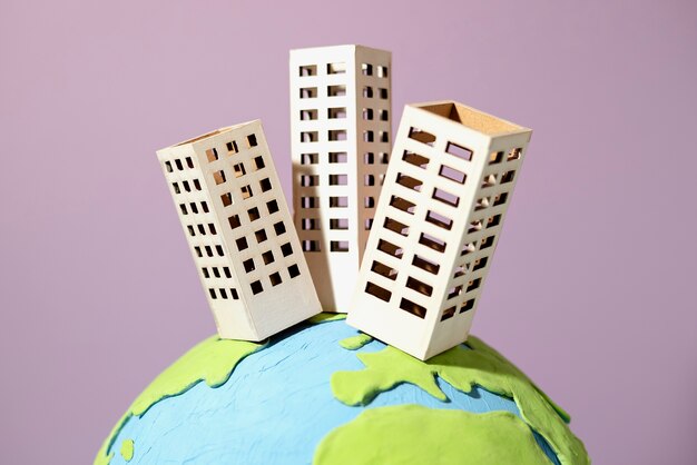 Земной шар в бумажном стиле со зданиями