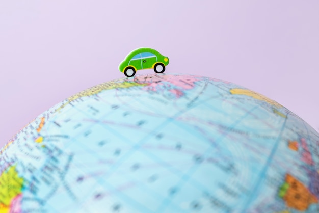Paper style earth globe with car