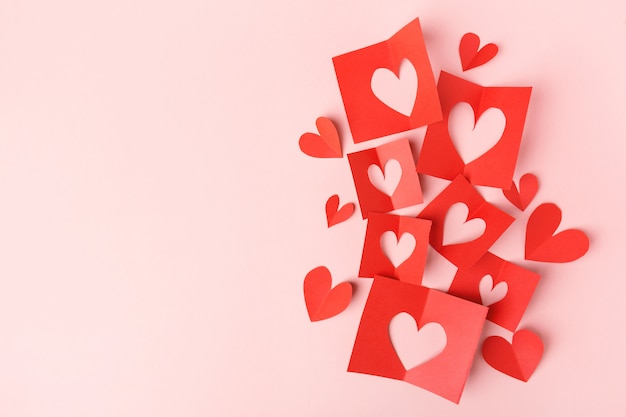 Paper valentines day hearts on pink