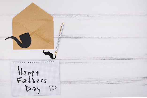 Free photo paper with happy father day title near ornament mustache and smoking pipe on letter