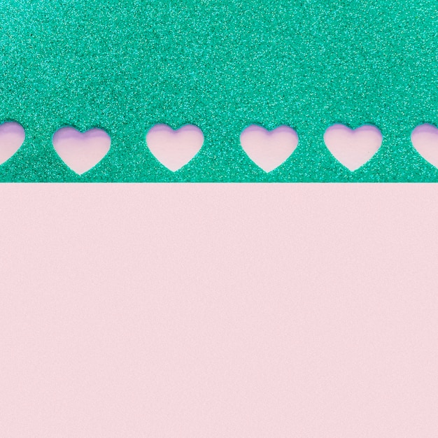 Paper with small cut hearts on purple table