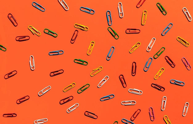 Free photo paperclips on orange background