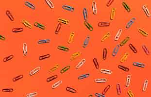 Free photo paperclips on orange background