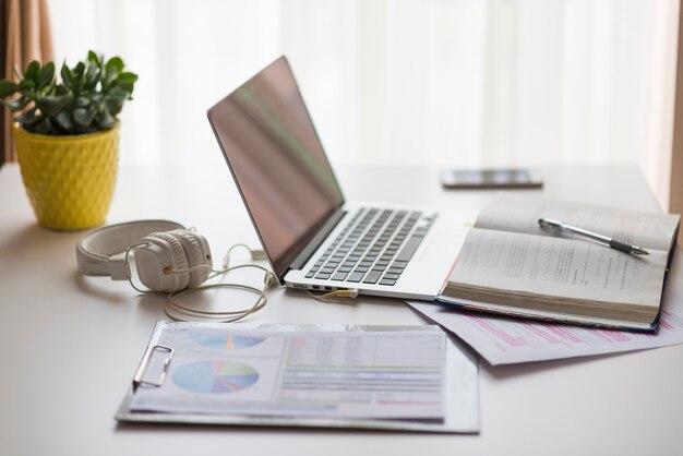 Papers and notebook near laptop