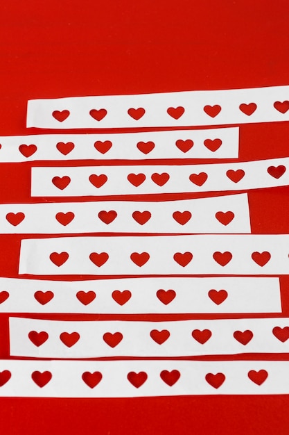 Free photo papers with cut hearts on table