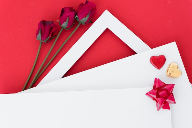 Бумаги с орнаментом сердца и лук возле цветов