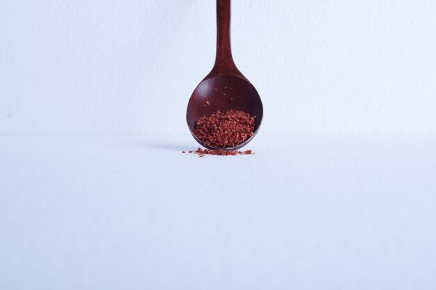 Paprika out of a wooden spoon.