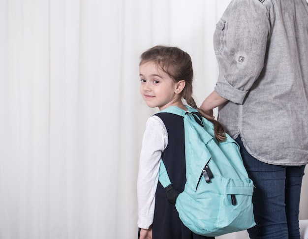 Free photo parent and primary school student go hand in hand