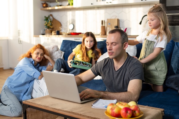 Free photo parent trying to work from home surrounded by kids