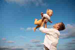 Free photo parent with a baby on the beach